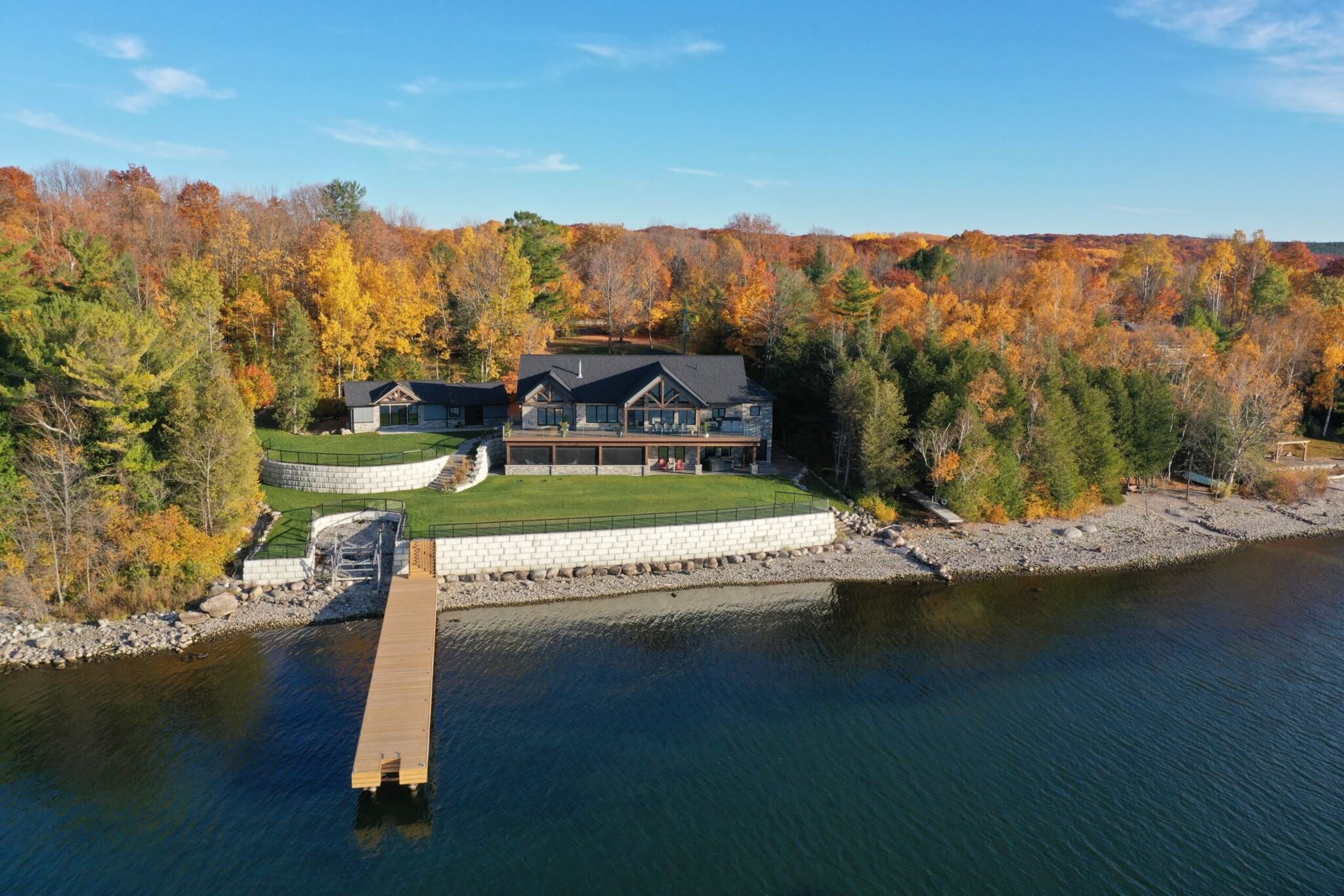 Beautiful two-storey home on Georgian Bay with a large yard and dock, surrounded by autumn colour